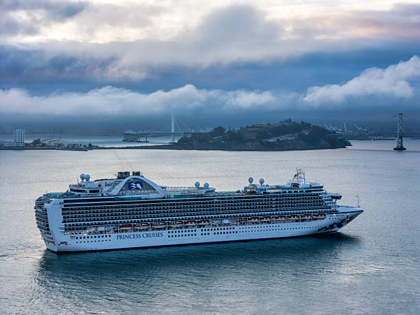 Aerial view of a Princess Cruise Ship In the San Francisco Bay heading to dock. Cloudy day with Yerba Buena Island in the background.