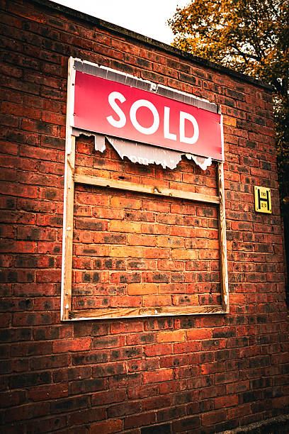 istock Torn 'SOLD' Sign on a Brick Wall, UK 2217961201