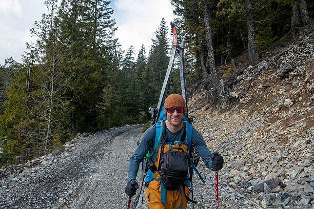 istock Backcountry splitboarder walks on road in forest 2217961350