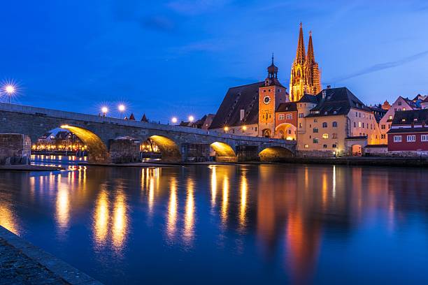 istock Regensburg's Stone Bridge and Cathedral at Night 2217962956