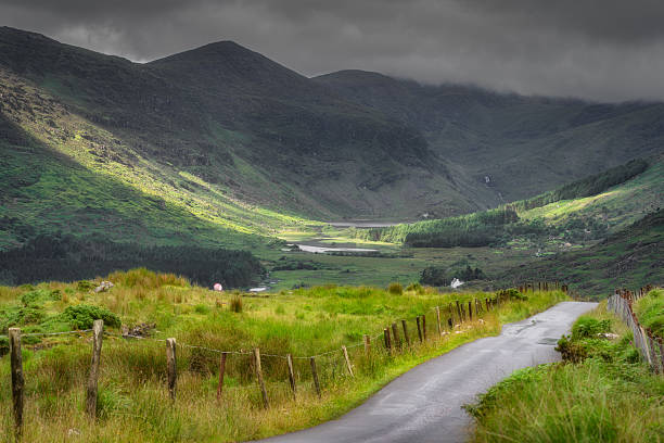 istock Serene Landscape Majestic Mountains and Lush Green Valley Beneath Dramatic and Beautiful Skies Above Us 2217965085