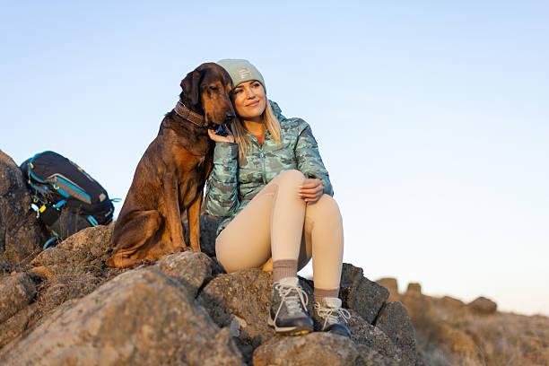 istock Woman with her dog taking a break from hiking 2217976622