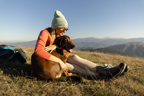 istock Woman with her dog taking a break from hiking 2217976701
