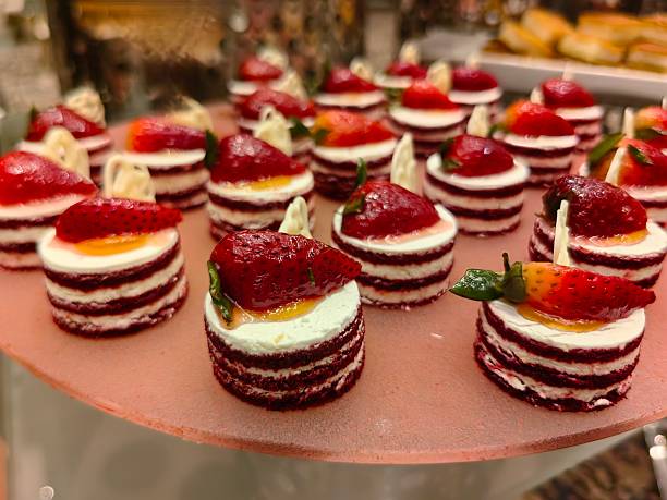 Slice of  delicious red velvet with strawberry on top.