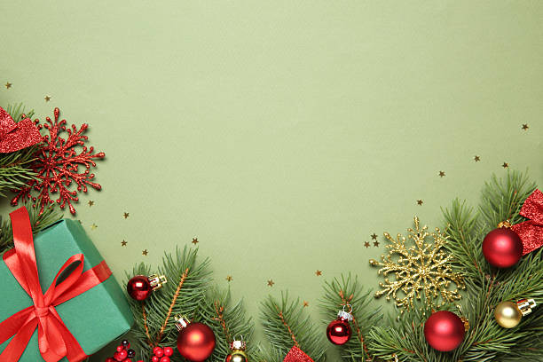 istock Flat lay composition with Christmas decor and gift box on green background, space for text 2217980893
