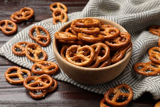 istock Tasty pretzel crackers on wooden table, closeup 2217981090