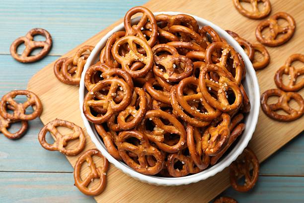 istock Tasty pretzel crackers on light blue wooden table, top view 2217981091