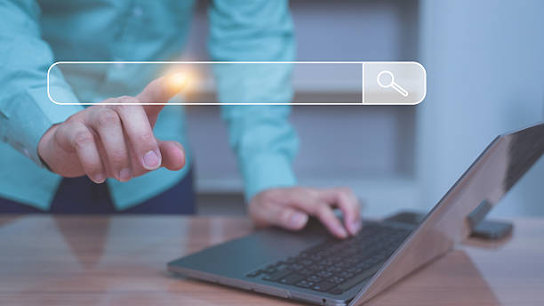 istock Hand Touching Search Bar on Virtual Screen with Laptop. 2217981306