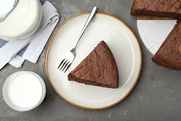 istock Piece of tasty chocolate sponge cake served on grey table, flat lay 2217981411