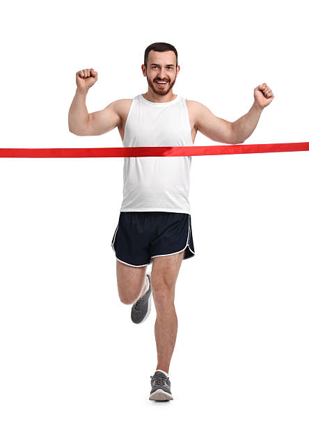 istock Handsome young man crossing red finish line on white background 2217981637