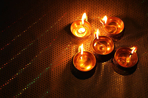 istock Diwali celebration. Diya lamps on color background. Space for text 2217981855