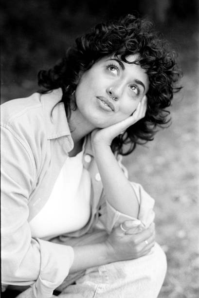 istock Young woman posing while looking up in black and white 2217981973