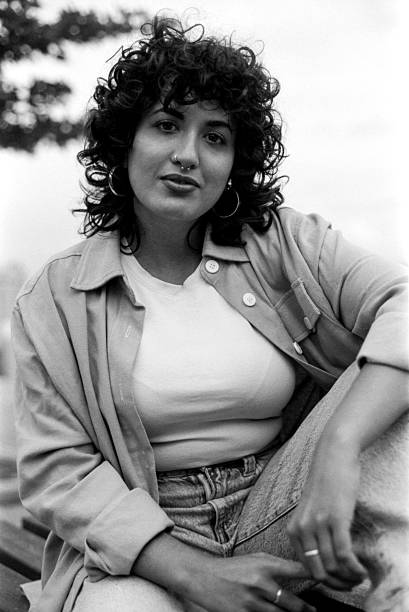 istock Young woman posing sitting outdoors in black and white 2217981981