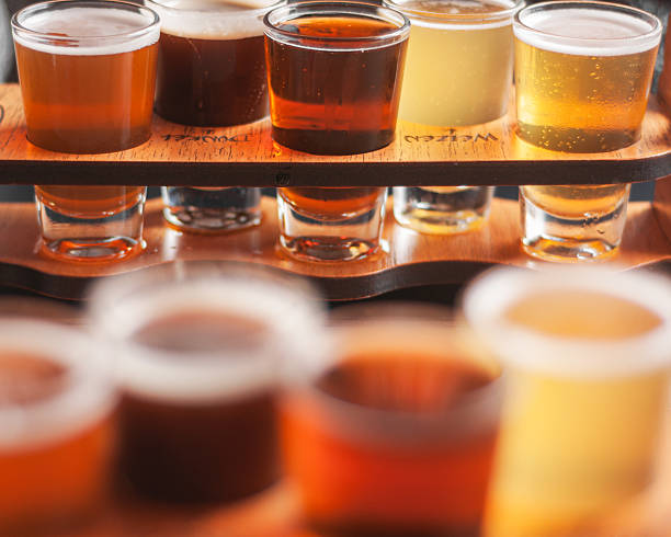 istock Craft beer flight with assorted tasting glasses on wooden tray 2217983072