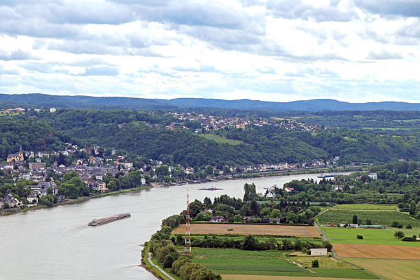 Large barges carrying cargo on the river rhine in Germany.