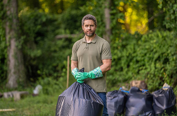 istock Save environment. Environment plastic pollution. Volunteer man collecting garbage in forest. Environmental protection. Man environmental activist. Environmental conservation. Plastic waste problem 2217987558
