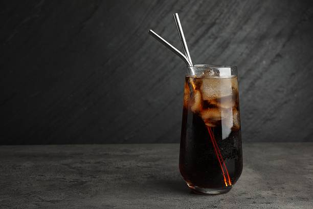 istock Tasty refreshing drink with straws in glass on grey textured table, space for text 2217988548