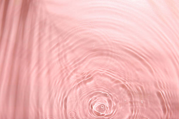 istock Rippled surface of clear water on pink background, top view 2217988615