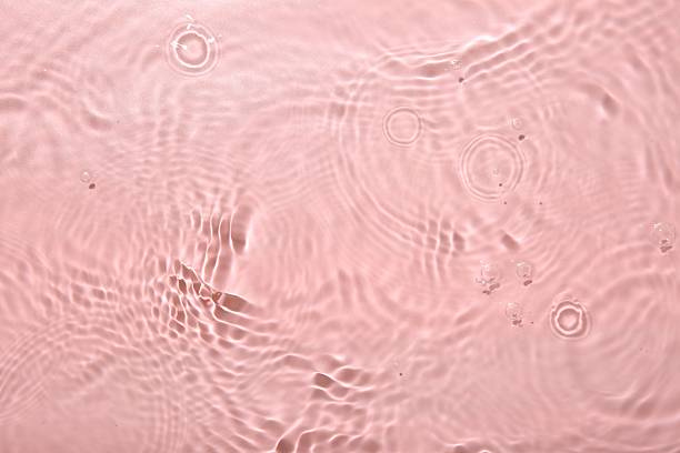 istock Rippled surface of clear water on pink background, top view 2217988618
