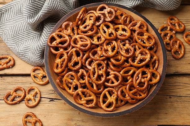 istock Delicious pretzel crackers on wooden table, flat lay 2217989974