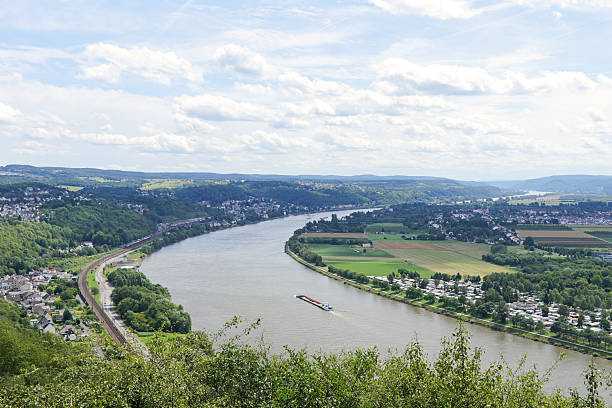 Large barges carrying cargo on the river rhine in Germany.