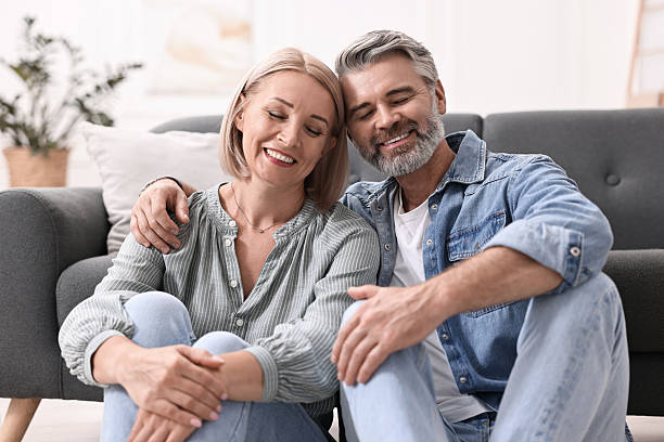 istock Happy middle aged couple on floor at home 2217990901