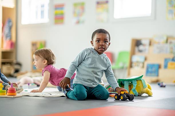 istock Children Engaged in Playtime Activities in a Bright Daycare Classroom Setting 2217993038