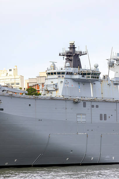 istock Closeup Navy ship at the dock, white background with copy space 2217993133