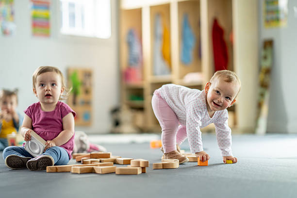 istock Young Children Playing With Blocks in a Bright Daycare Classroom 2217993193