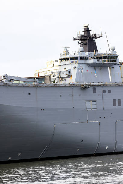istock Closeup Navy ship at the dock, white background with copy space 2217993209