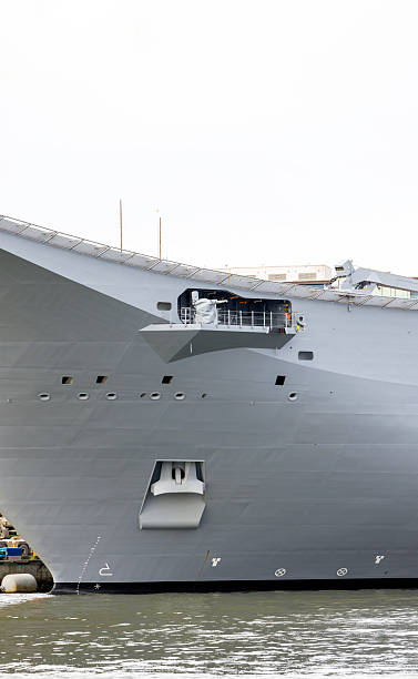 istock Closeup Navy ship at the dock, white background with copy space 2217993465