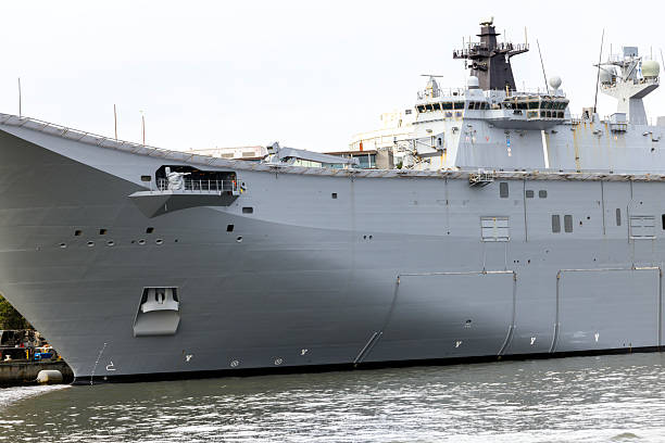 istock Closeup Navy ship at the dock, white background with copy space 2217994642