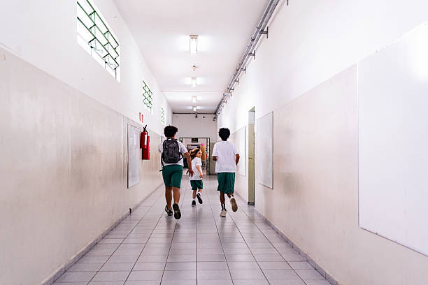 Schoolboys running on the school hallway