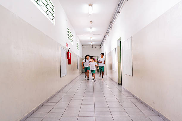 Schoolboys running on the school hallway