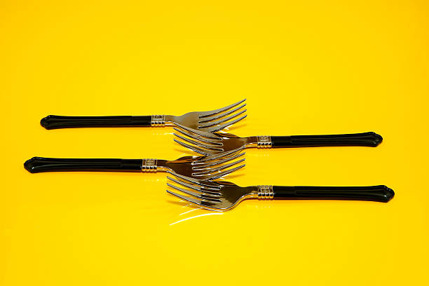 istock Fork set together placed on yellow background closeup shot 2217995629