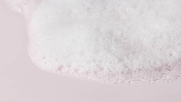 istock Cosmetic foam smear on pastel pink background, minimal beauty texture 2217997527