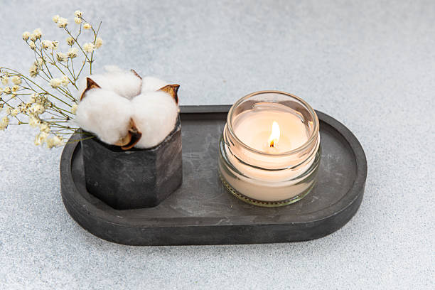 Stylish home decor featuring cotton and candle on a modern tray with minimalistic design