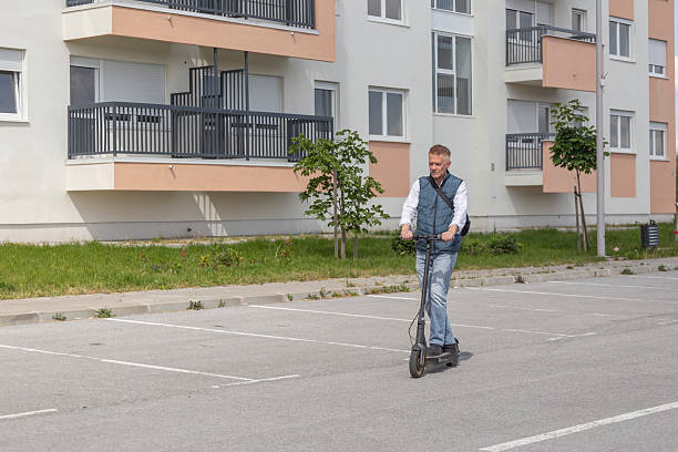Commuter with e scooter in the city. Concept sustainable lifestyle, saving energy, lowering green house gases.