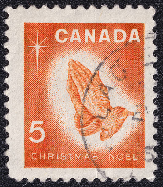 istock Praying Hands and the words Christmas Noel on a 1966 Canada postage stamp 2218000827