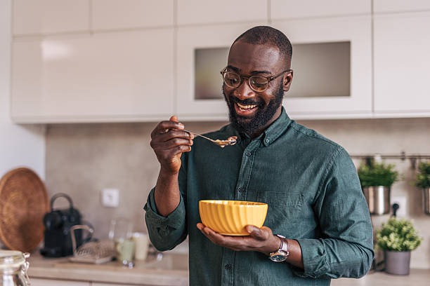 istock Happy man eating breakfast in a modern kitchen 2218001672