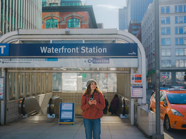istock Woman using smartphone leaving Waterfront station in Vancouver, Canada 2218001856