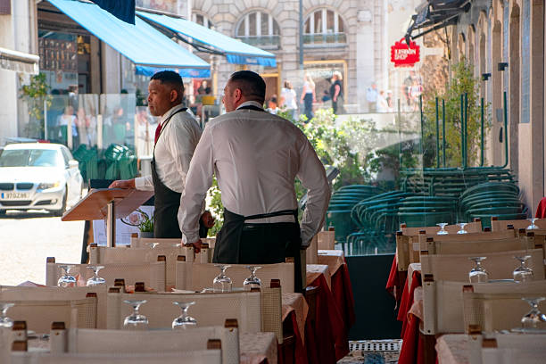 Two waiters at an outdoor restaurant, Lisbon, Portugal, 05/01/2024
