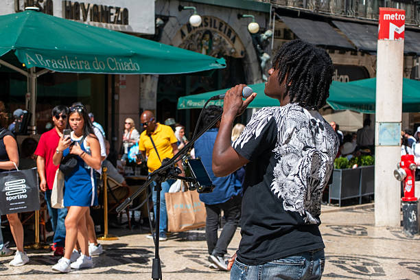 A street performer singing into a microphone on a sunny day. Lisbon, Portugal, 05/01/2024