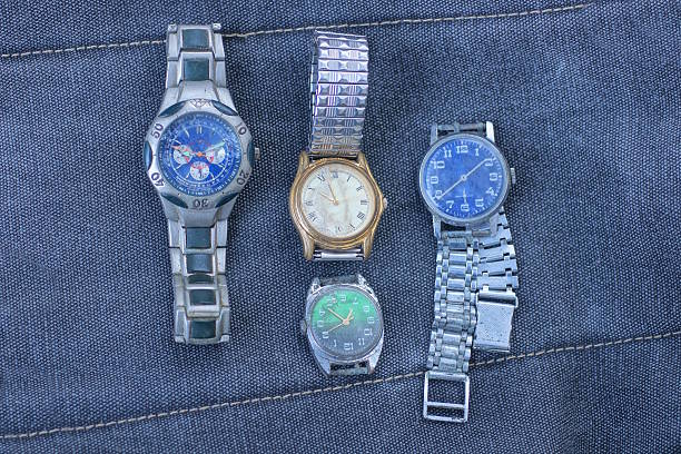Color image depicting vintage chronograph wristwatches on a red background.