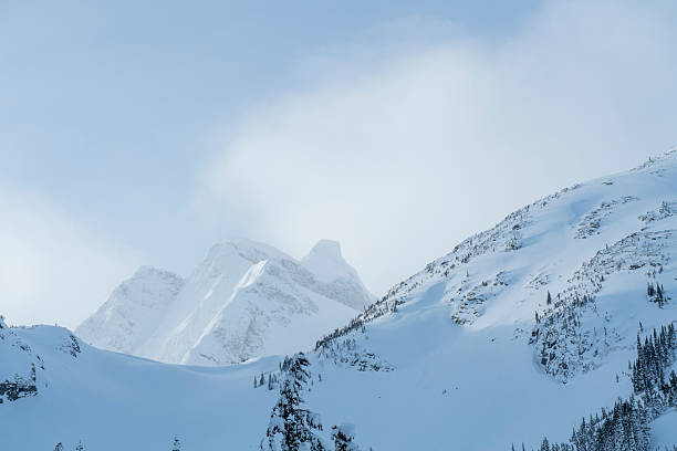 An epic mountain landscape with tiny skiers visible.