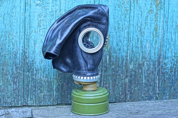istock one old army rubber black gas mask stands on a gray table 2218002496
