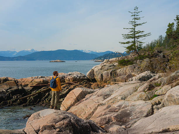 istock Man hiking in Lighthouse Park in West Vancouver, Canada 2218002965