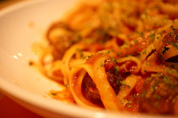 Mediterranean pasta with meatballs  and parsley in close-up