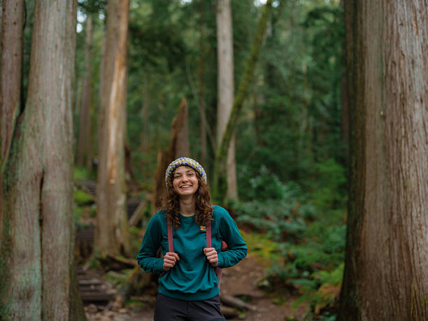 Woman enjoying  serenity during the hike in the forest in Vancouver, Canada in summer