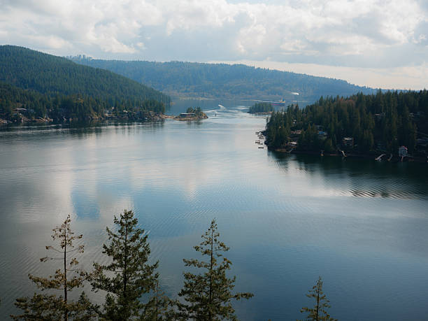 A quiet inlet in North Vancouver is surrounded by dense forest. British Columbia, Canada